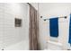 Shower over the tub area featuring white tiling, a shower caddy, and grey shower curtain at 581 Fairview Blvd, Breckenridge, CO 80424