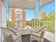 Outdoor balcony with city views and white wicker chairs to sit and relax at 1200 N Humboldt St # 604, Denver, CO 80218