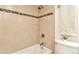 Cozy bathroom featuring white tiled walls and a shower and tub combo for relaxation at 1200 N Humboldt St # 604, Denver, CO 80218