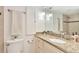 Bathroom featuring granite counters, modern lighting, storage cabinet, and neutral-toned tiles at 1200 N Humboldt St # 604, Denver, CO 80218
