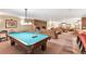 Game room with a pool table, brick fireplace, seating area, and ample space for entertaining at 1200 N Humboldt St # 604, Denver, CO 80218