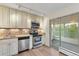 Kitchen with stainless steel dishwasher and range, granite countertops and access to a sunroom at 1200 N Humboldt St # 604, Denver, CO 80218