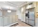 Kitchen featuring stainless steel refrigerator, light wood cabinets, and granite countertops at 1200 N Humboldt St # 604, Denver, CO 80218