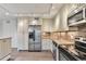Well-lit kitchen with stainless steel appliances, granite countertops, and light wood cabinets at 1200 N Humboldt St # 604, Denver, CO 80218