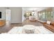 Bright living room featuring wood floors, a marble coffee table, and a dining area with sliding glass doors to a balcony at 1200 N Humboldt St # 604, Denver, CO 80218