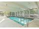 Indoor pool with bright light and views of the surrounding trees and outdoor patio at 1200 N Humboldt St # 604, Denver, CO 80218