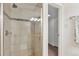 Shower with glass door, tile surround, and updated showerhead and fixtures at 1200 N Humboldt St # 604, Denver, CO 80218