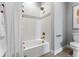 Clean bathroom showcasing white tile, a shower-tub combo, and modern fixtures at 5591 Farrier Pt, Castle Rock, CO 80104