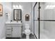 Modern bathroom featuring white vanity with gold hardware, stylish mirror, and a glass-enclosed shower at 5591 Farrier Pt, Castle Rock, CO 80104