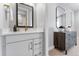 Stylish bathroom featuring a modern vanity with gold hardware and faucets, plus elegant mirrors at 5591 Farrier Pt, Castle Rock, CO 80104