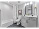 Bathroom featuring modern fixtures, white cabinets, and a shower and tub combo at 5591 Farrier Pt, Castle Rock, CO 80104