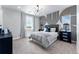 Decorated bedroom showcasing contemporary design elements, a modern light fixture, and abundant natural light at 5591 Farrier Pt, Castle Rock, CO 80104