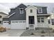 Charming home featuring a two-car garage, modern gray siding, stone accents, and well-maintained landscaping at 5591 Farrier Pt, Castle Rock, CO 80104
