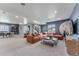 A spacious living area with dining area, plush sofa, and ample natural light from multiple windows at 5591 Farrier Pt, Castle Rock, CO 80104