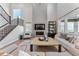 Stunning living room with soaring ceilings, modern fireplace, and an abundance of natural light at 5591 Farrier Pt, Castle Rock, CO 80104