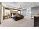 Spacious main bedroom with tray ceilings, modern chandelier, and an ensuite bathroom at 5591 Farrier Pt, Castle Rock, CO 80104