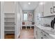 Functional mud room with built-in bench, storage, and access to the pantry and garage at 5591 Farrier Pt, Castle Rock, CO 80104
