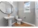 Chic powder room with modern fixtures, elegant mirror, and convenient layout at 5591 Farrier Pt, Castle Rock, CO 80104