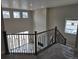 Spacious living area with a modern staircase, contemporary railing, high ceilings, and abundant natural light at 5591 Farrier Pt, Castle Rock, CO 80104