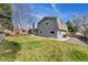 Lush backyard with a well-manicured lawn, mature trees and modern exterior at 2477 S Dover Way, Lakewood, CO 80227