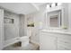 Updated bathroom with a tiled shower, modern vanity, and neutral decor at 2477 S Dover Way, Lakewood, CO 80227