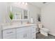 Bright bathroom with a white vanity and a large mirror at 2477 S Dover Way, Lakewood, CO 80227