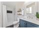 Modern bathroom featuring a tiled shower with a dark accent and a vanity at 2477 S Dover Way, Lakewood, CO 80227