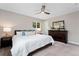 Serene bedroom with soft lighting, a comfortable bed, and a classic dark dresser at 2477 S Dover Way, Lakewood, CO 80227