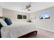 Calm and airy bedroom with natural light from two windows and a ceiling fan at 2477 S Dover Way, Lakewood, CO 80227