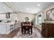 Bright dining area with a stylish table set, and natural light filtering through the window at 2477 S Dover Way, Lakewood, CO 80227