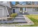 Inviting home entrance featuring a modern walkway, manicured landscaping, and a charming seating area on the porch at 2477 S Dover Way, Lakewood, CO 80227