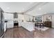 Modern kitchen open to dining area, featuring white cabinetry, stainless steel appliances, and sleek countertops at 2477 S Dover Way, Lakewood, CO 80227