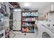 Well-organized laundry and storage area with shelving and modern appliances at 2477 S Dover Way, Lakewood, CO 80227