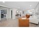 Open-concept living area with carpet, modern decor, including nearby laundry and bathroom at 2477 S Dover Way, Lakewood, CO 80227