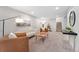 Inviting living room with neutral tones, plush carpet, modern lighting, and stylish decor at 2477 S Dover Way, Lakewood, CO 80227