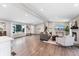 Spacious open-plan living room with recessed lighting, a fireplace, and large windows at 2477 S Dover Way, Lakewood, CO 80227