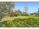 Vast, green backyard with mature trees and a wooden fence, offering privacy at 6477 W Clifton Pl, Littleton, CO 80128