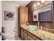 Bathroom featuring a glass sink and wooden vanity at 6477 W Clifton Pl, Littleton, CO 80128