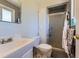 Bright bathroom features white fixtures and a shower with glass doors at 6477 W Clifton Pl, Littleton, CO 80128
