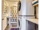 Functional bathroom featuring stacked washer and dryer unit, sink, and shower with patterned curtain at 6477 W Clifton Pl, Littleton, CO 80128