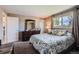 Comfortable bedroom featuring a large window, cozy carpeting, and a dresser at 6477 W Clifton Pl, Littleton, CO 80128