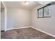 Cozy bedroom with neutral walls, plush carpet, and window providing natural light at 6477 W Clifton Pl, Littleton, CO 80128