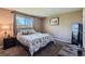 Comfortable bedroom featuring a large window and cozy carpeting at 6477 W Clifton Pl, Littleton, CO 80128