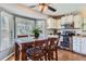 Cozy dining area features a large sunny window, built-in oven and stove top, and stainless-steel appliances at 6477 W Clifton Pl, Littleton, CO 80128