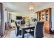 The dining room features hardwood floors and views to the living room and front yard at 6477 W Clifton Pl, Littleton, CO 80128