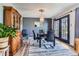 Elegant dining area with modern lighting and furniture near the walkout deck at 6477 W Clifton Pl, Littleton, CO 80128
