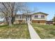 Charming two-story home with a well-manicured lawn and mature trees at 6477 W Clifton Pl, Littleton, CO 80128