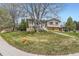 Inviting two-story home with manicured front yard, mature trees, and charming facade at 6477 W Clifton Pl, Littleton, CO 80128