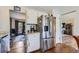 Bright kitchen featuring stainless steel refrigerator and an adjacent dining area at 6477 W Clifton Pl, Littleton, CO 80128