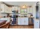 Well-lit kitchen featuring white cabinets, stainless steel appliances, and granite countertops at 6477 W Clifton Pl, Littleton, CO 80128